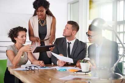 team of successful business people having a meeting in executive sunlit office